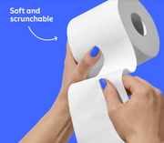 A close-up of a person's hands with blue nail polish holding a roll of toilet paper against a solid blue background, with the text 'Soft and scrunchable' and a curved arrow pointing to the toilet paper texture.